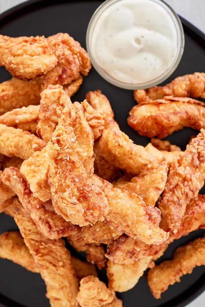overhead view of beer battered chicken on a platter.