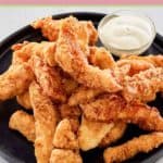 beer battered chicken strips on a platter.