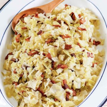 boiled cabbage with bacon on a serving platter.