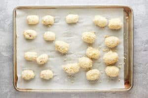 breaded loaded baked potato tots before frying.