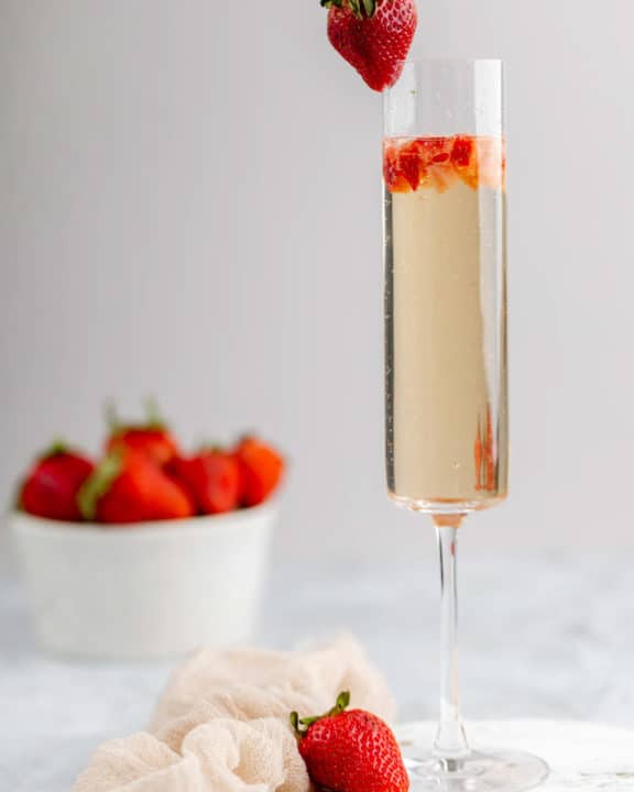 copycat Grand Lux Cafe Strawberry Bellini garnished with a strawberry.