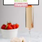 copycat Grand Lux Cafe Strawberry Bellini and a bowl of strawberries.