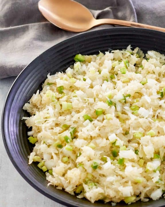 sauerkraut salad in a bowl and a spoon next to it.