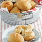 copycat Texas Roadhouse rolls in a metal tub and on a plate.