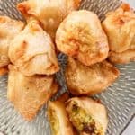 overhead view of vegetable samosas on a platter.
