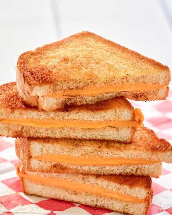 air fryer grilled cheese sandwich slices on parchment paper.
