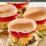 air fryer burgers with toppings on a wood board.