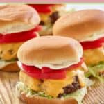 air fryer hamburgers on a wood board.