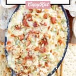 hot bacon and swiss cheese dip with crackers and bread around it.