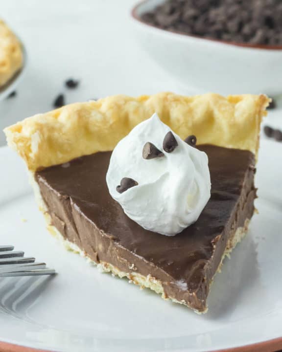 homemade chocolate pie with a dollop of whipped cream on top.