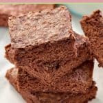 four homemade fudge brownies in a stack.