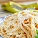 copycat olive garden alfredo sauce with fettuccine in a blue bowl.
