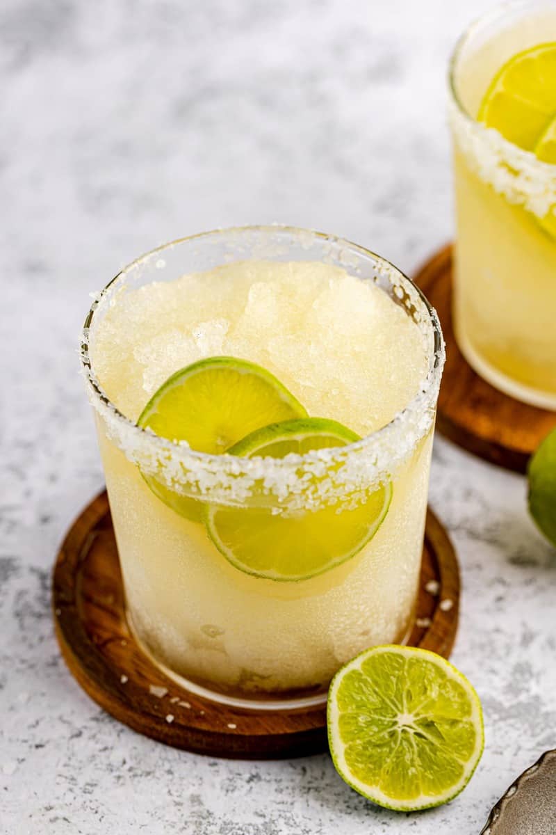 beer margarita garnished with a salt rim and lime slices.