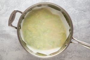 parchment paper covering rice pilaf in a pan.