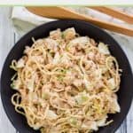 overhead view of shrimp pasta salad in a black bowl.