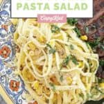 fettuccine pasta salad on a colorful plate.