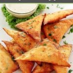 wonton jalapeno poppers with dipping sauce on a white plate.
