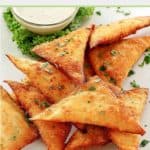 wonton jalapeno poppers and dipping sauce on a plate.