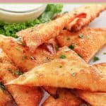 wonton jalapeno poppers on a white plate.