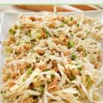 crunchy Asian slaw on a white platter.
