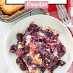 overhead view of blackberry cobbler on a plate and a fork.