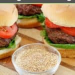 bowl of homemade burger seasoning in front of burgers.