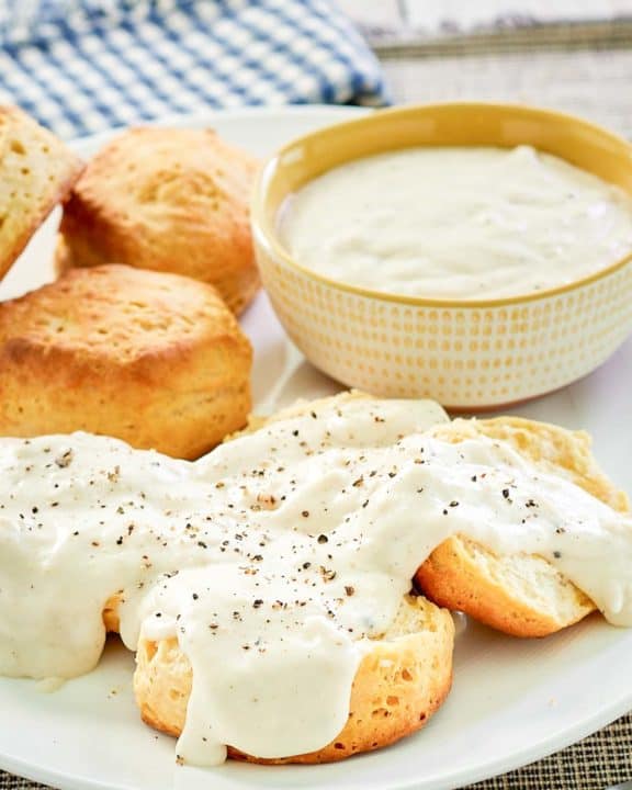 copycat Cracker Barrel sawmill gravy over biscuits and in a bowl.