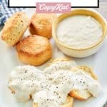 homemade Cracker Barrel sawmill gravy and biscuits on a plate.