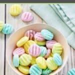 cream cheese mints in a bowl and scattered around it.