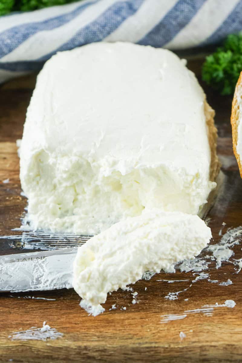 block of homemade cream cheese on a wood board.