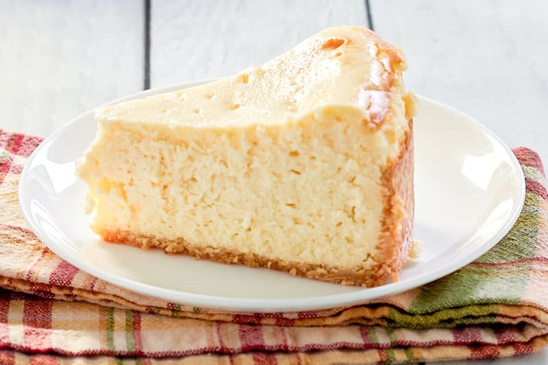 a slice of copycat Lindy's New York cheesecake on a plate.