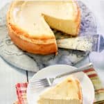 homemade Lindy's New York Cheesecake on a platter and slice on a plate.