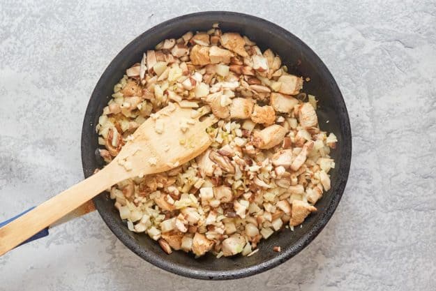 chicken, mushrooms, bamboo shoots, and water chestnuts in a skillet.