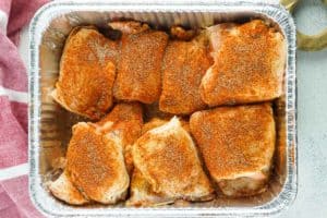 raw chicken thighs with dry rub on them.