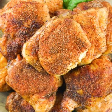 overhead view of smoked chicken thighs on a platter.