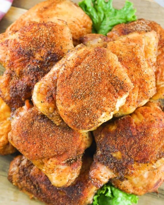 overhead view of smoked chicken thighs on a platter.