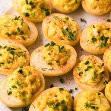 smoked deviled eggs on a round white platter.