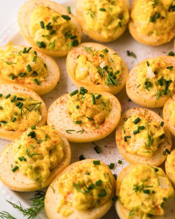 smoked deviled eggs on a round white platter.