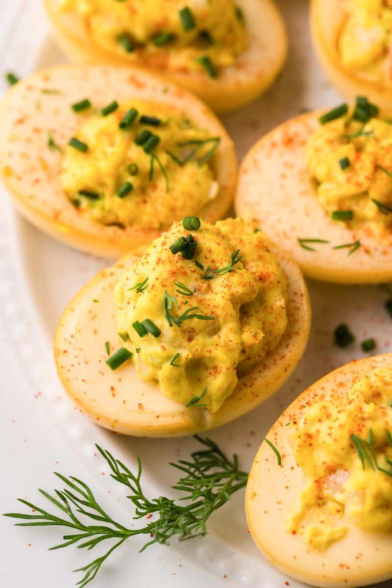 smoked deviled eggs topped with chives and fresh dill.