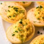 closeup of smoked deviled eggs on a plate.