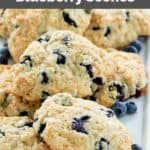 closeup of homemade Starbucks blueberry scones and blueberries on a platter.