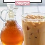homemade Starbucks vanilla syrup in a small pitcher and an iced coffee.