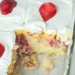 strawberry poke cake in a glass baking dish.