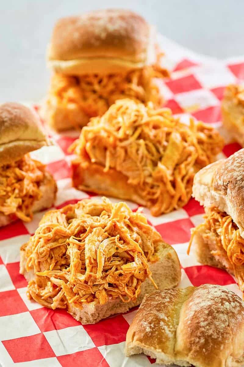 a few buffalo chicken sliders on parchment paper.