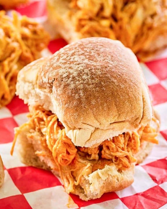 buffalo chicken slider on red checkered parchment paper.
