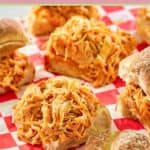 several buffalo chicken sliders on parchment paper.