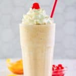 homemade Chick Fil A peach milkshake in a tall glass.