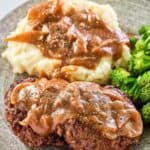 homemade Cracker Barrel hamburger steak and gravy on a plate.