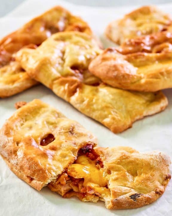 homemade ham and cheese pockets on parchment paper.
