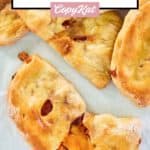 overhead view of ham and cheddar cheese hot pockets with one split open.